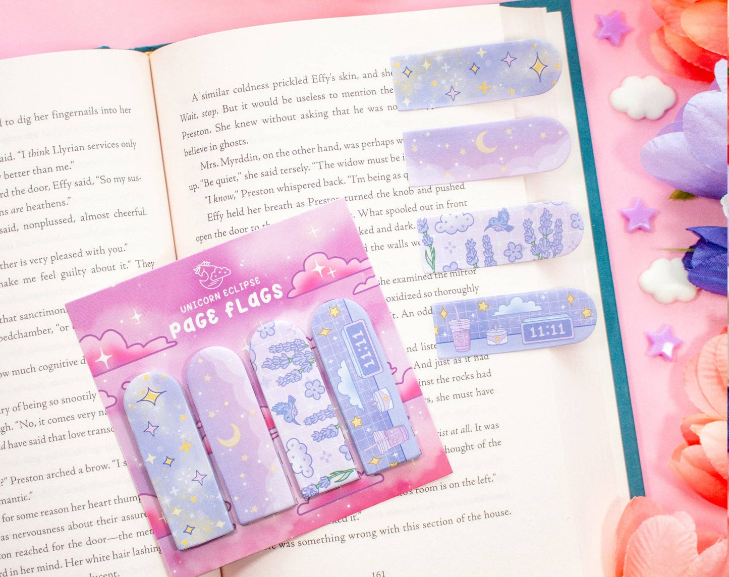 Set of colorful page flags with a pink packaging on an open book.