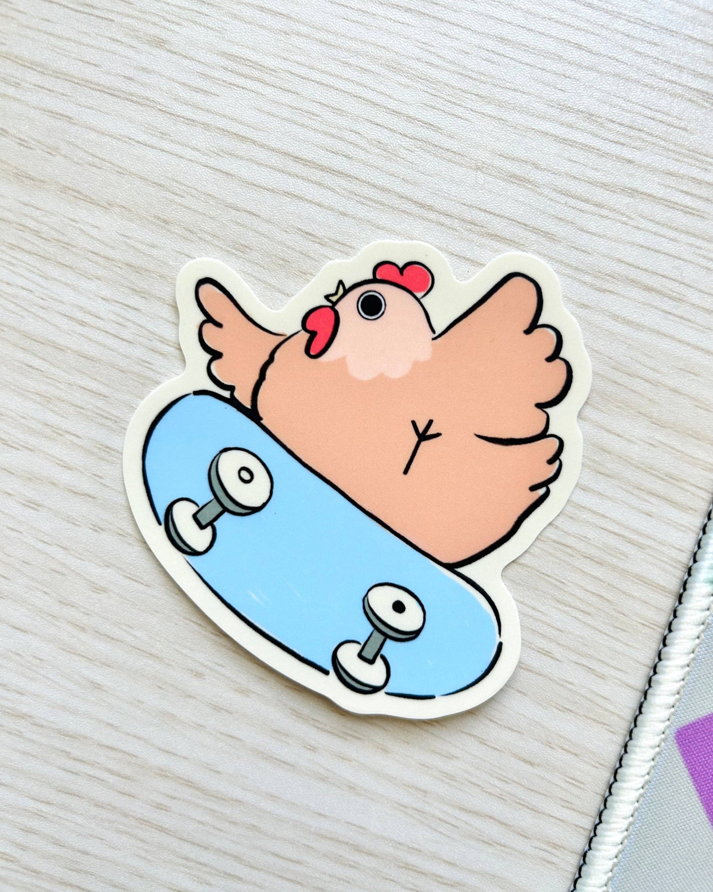 Sticker of a cartoon chicken on a skateboard with a light gray background, Rad Skater Chicken Sticker
