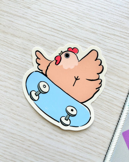 Sticker of a cartoon chicken on a skateboard with a light gray background, Rad Skater Chicken Sticker