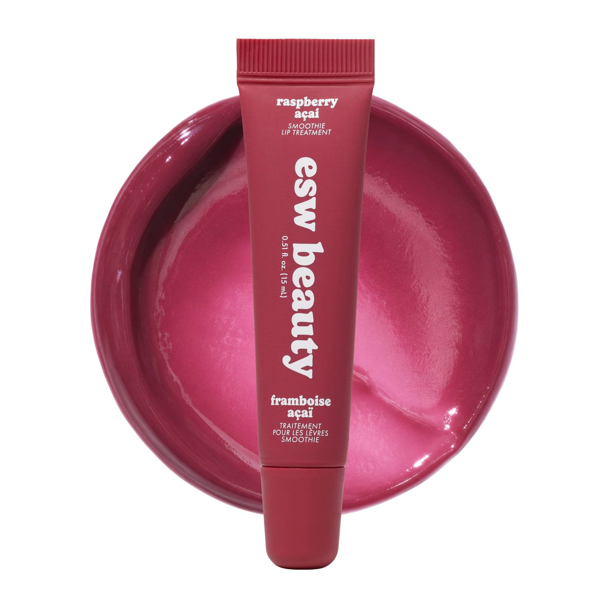 Lip balm tube with 'esw beauty' branding on a pink background