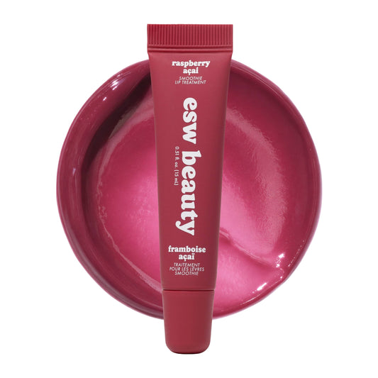 Lip balm tube with 'esw beauty' branding on a pink background