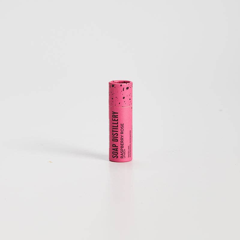 Pink cylindrical soap container with 'Soap Distillery' branding on a white background