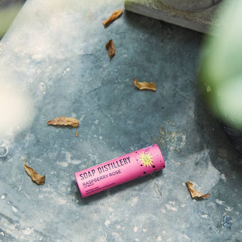 Pink soap bar with 'Soap Distillery' branding on a textured surface