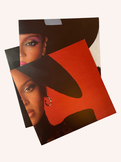 Two vinyl covers featuring a woman's face with a black hat and red, background. Renaissance Vinyl Record - Beyonce