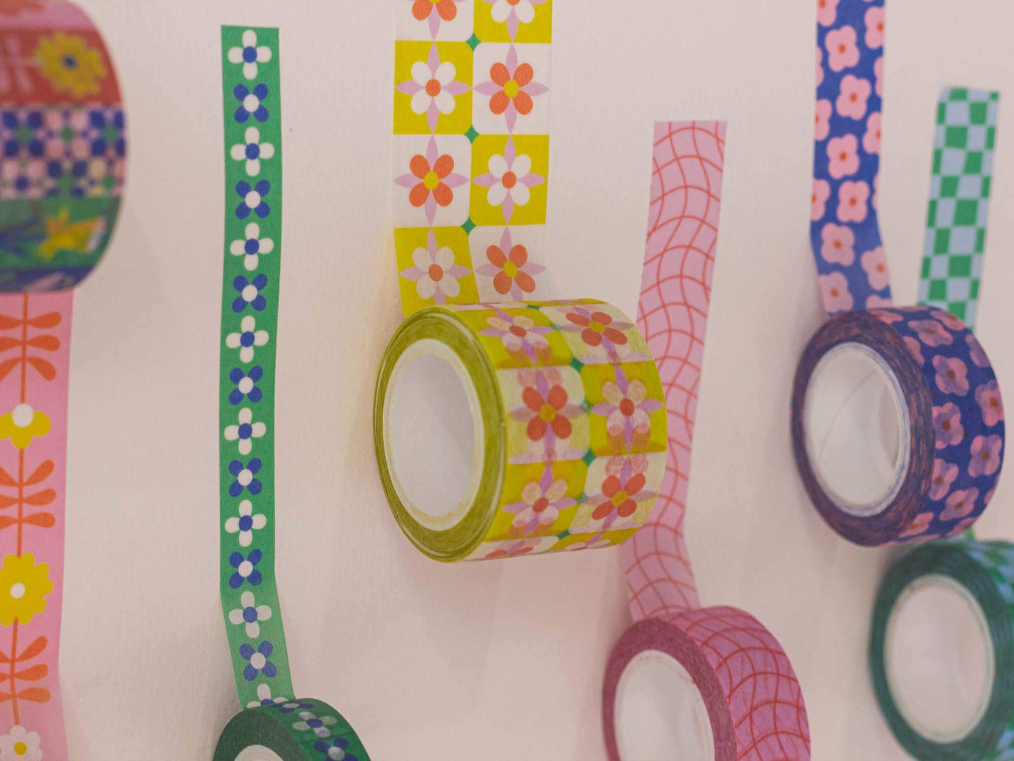 Colorful washi tape rolls with various patterns on a white background