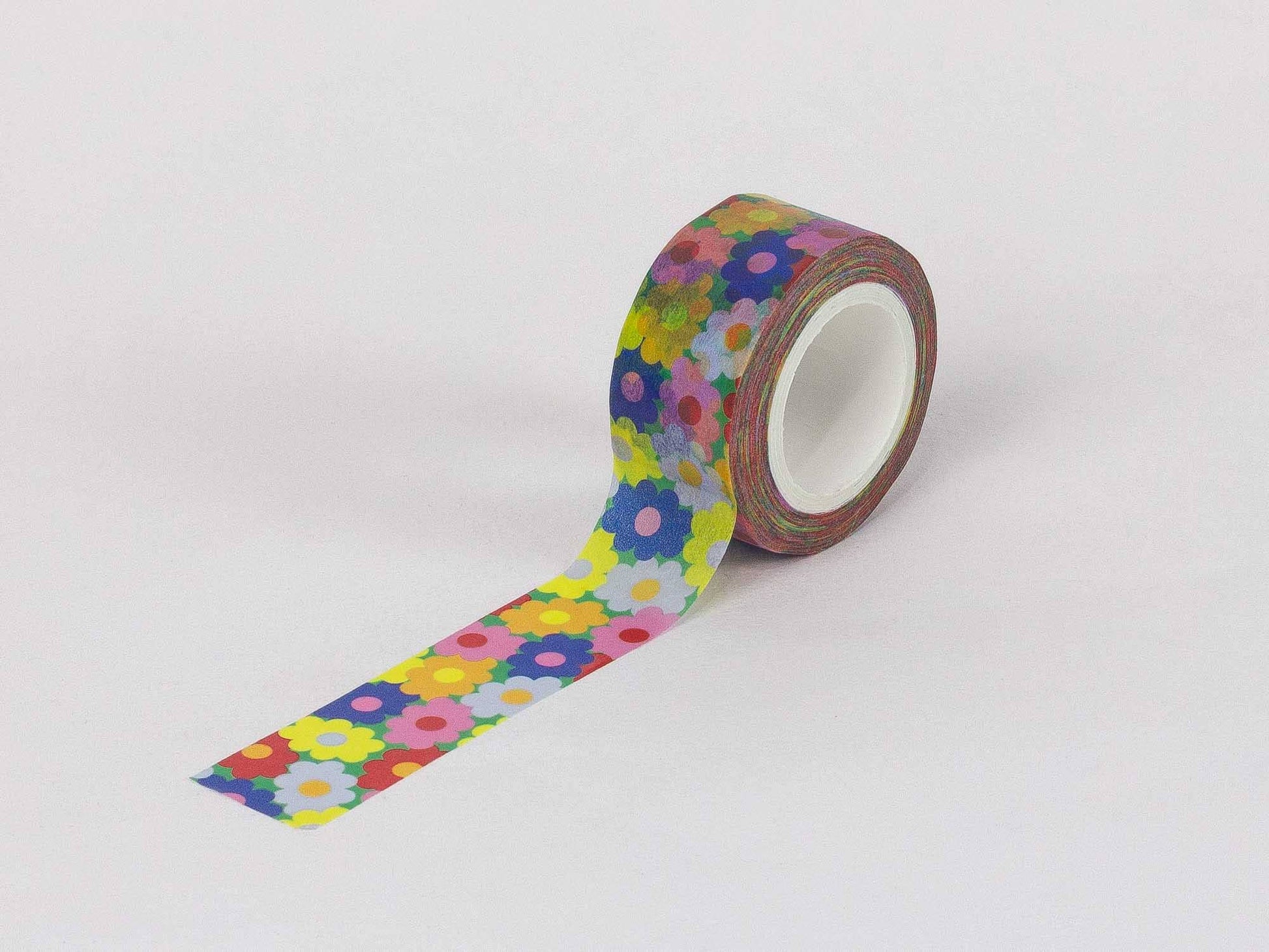 Roll of colorful floral-patterned tape on a white background
