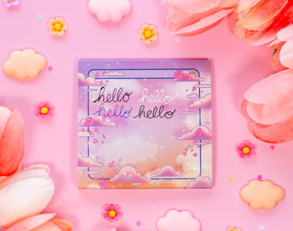 Sticky notes with 'hello' text on a pink background with flowers and clouds
