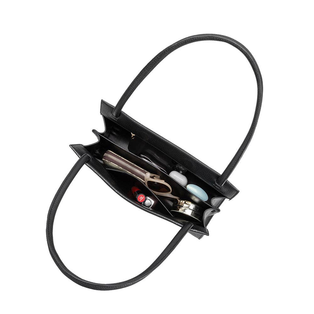 Black handbag with open compartment showing hair styling tools on a white background