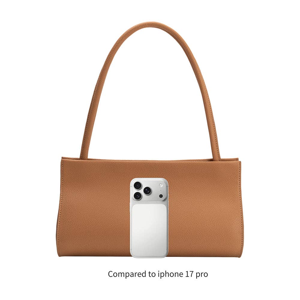 Brown handbag with a phone inside, compared to iPhone 17 Pro on a white background