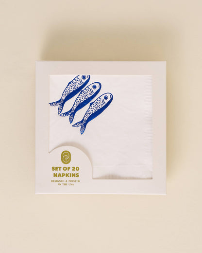 Pack of napkins with blue fish design on a beige background