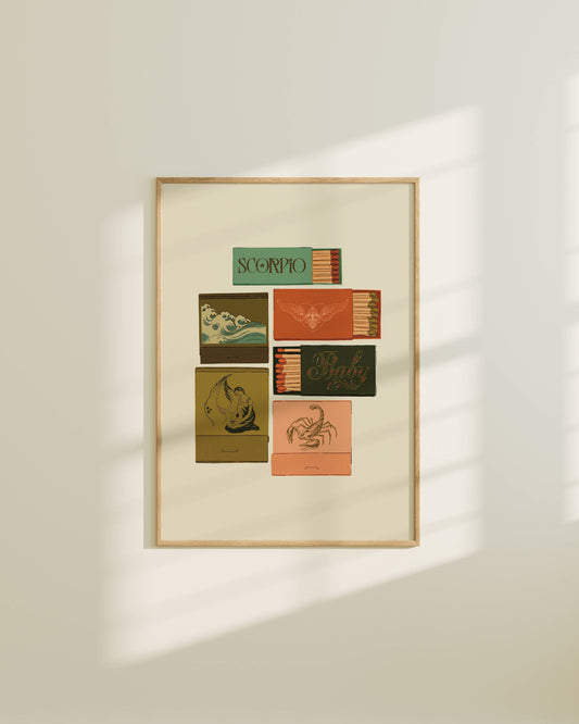 Framed artwork with zodiac card designs on a white wall