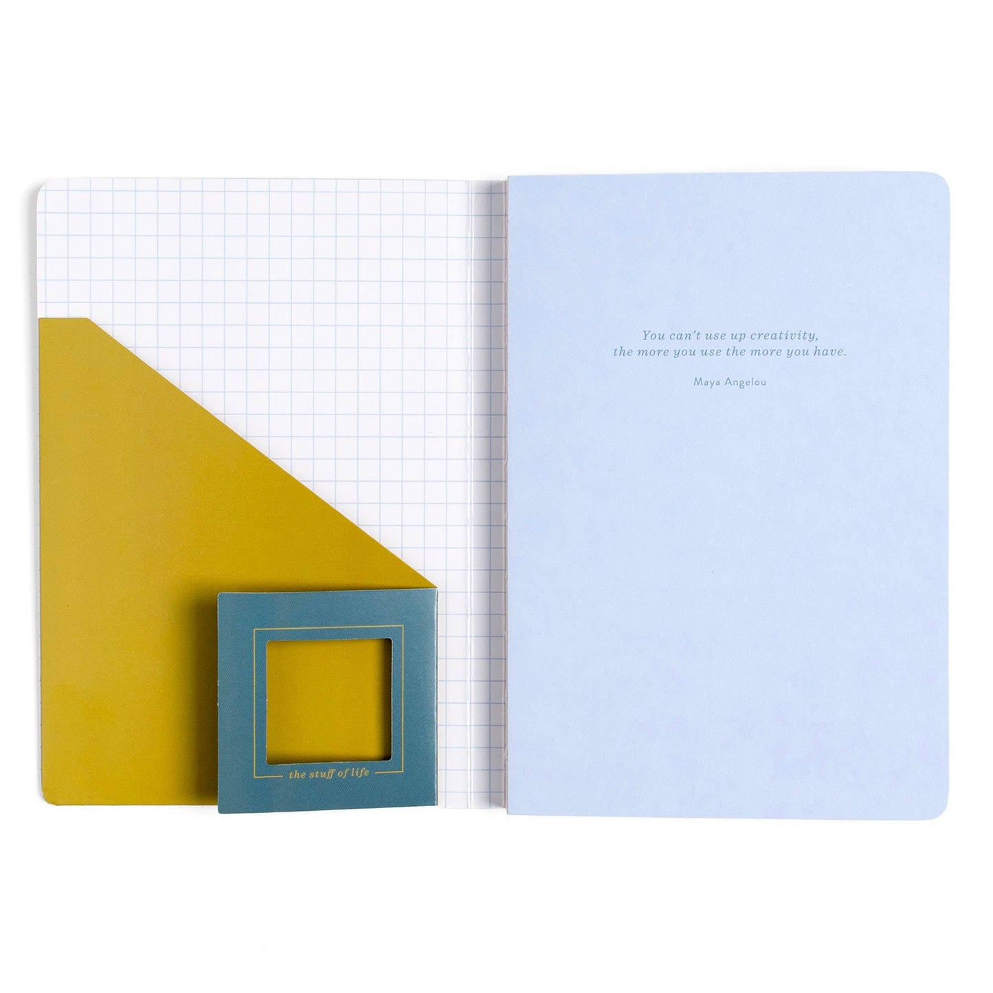 An open notebook or journal with a light blue right page featuring a quote by Roy Douglas, a white left page with a faint grid, a large mustard yellow geometric accent on the left, and a small teal square card with a yellow insert.