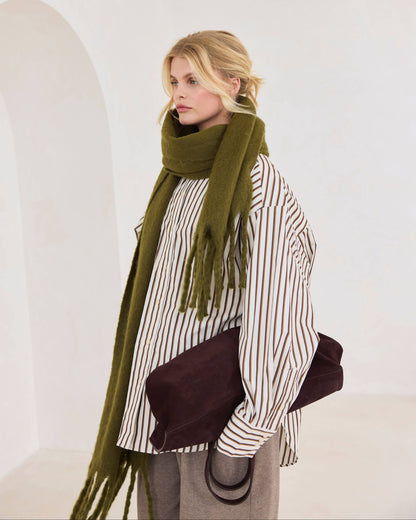 Woman wearing a green scarf and striped shirt against a white background, Sea Kelp Green Reykjavik Recyled Bottle Scarf
