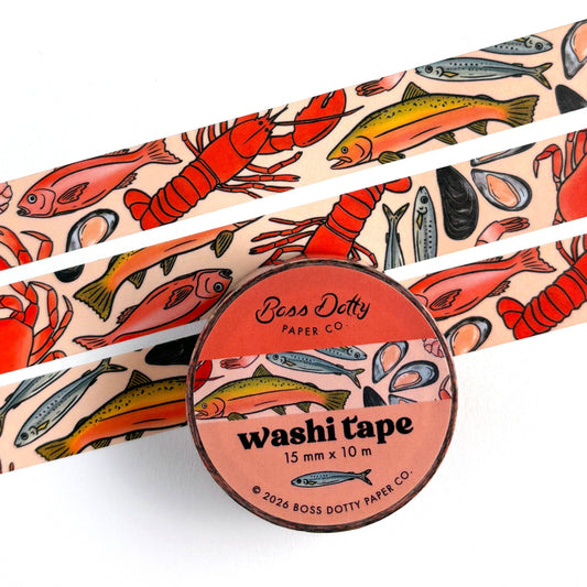Washi tape with fish and lobster design and a container labeled 'Boss Dotty Paper Co.'