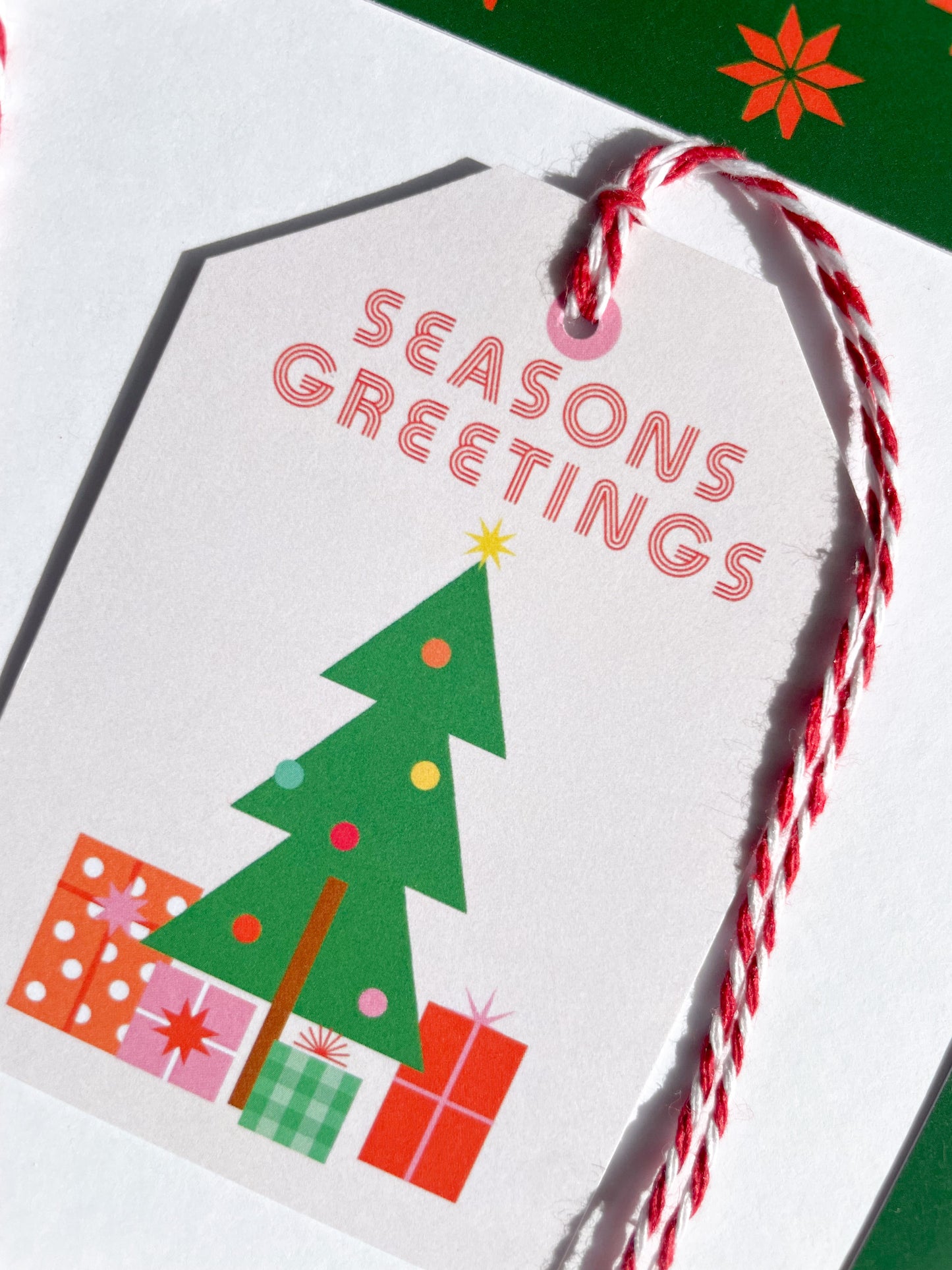 Christmas gift tag with 'Seasons Greetings' text and festive illustrations on a white background. Seasons Greetings Gift Tag Set of 6