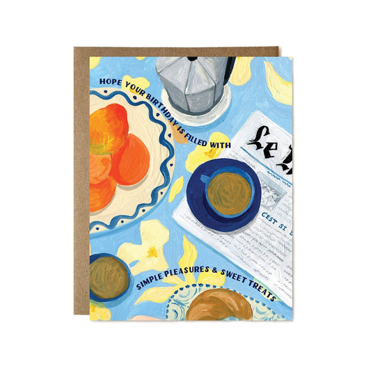 Greeting card with illustrations of a teacup, cookies, and a newspaper on a blue background.