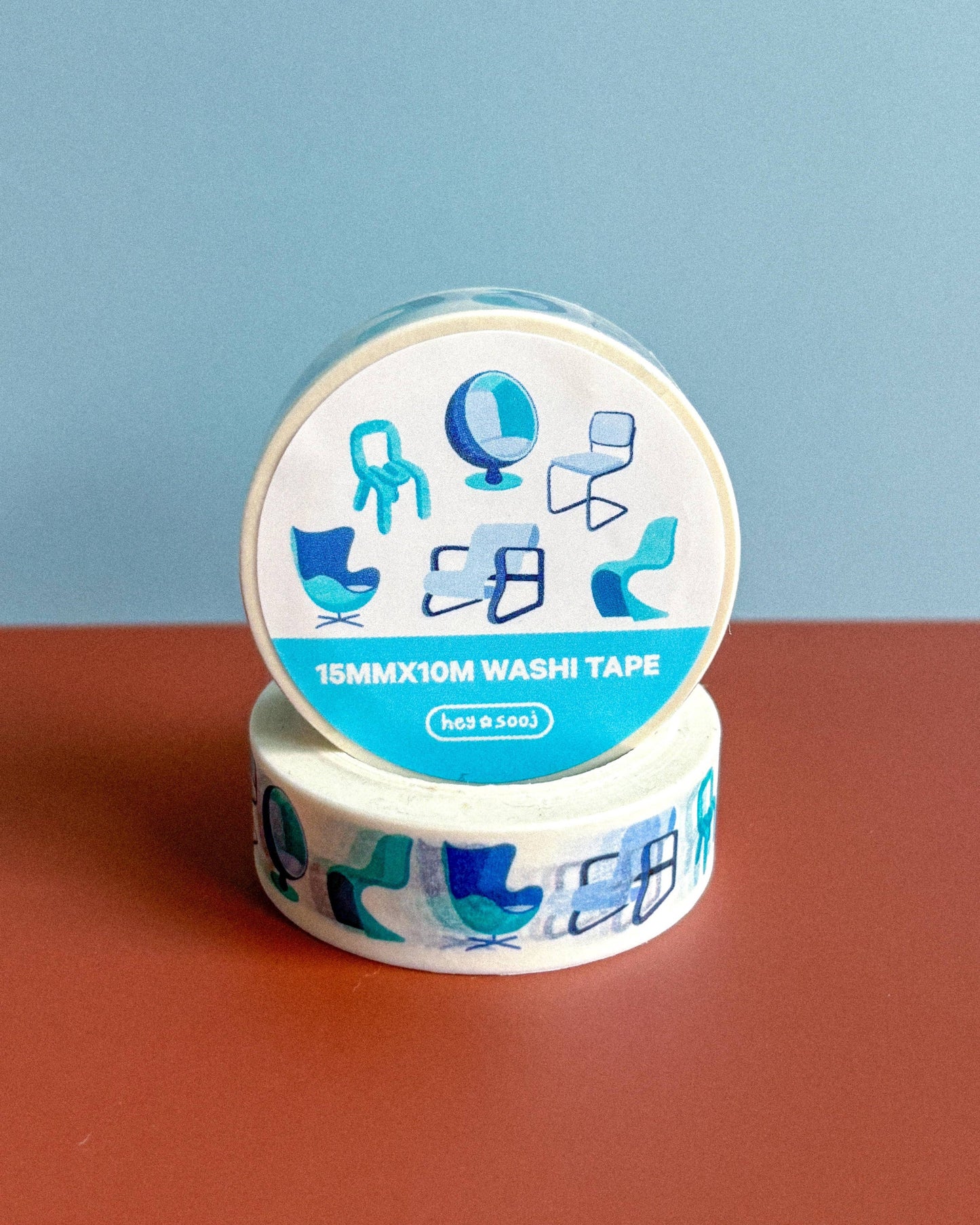Washi tape with decorative design on a red surface and blue background