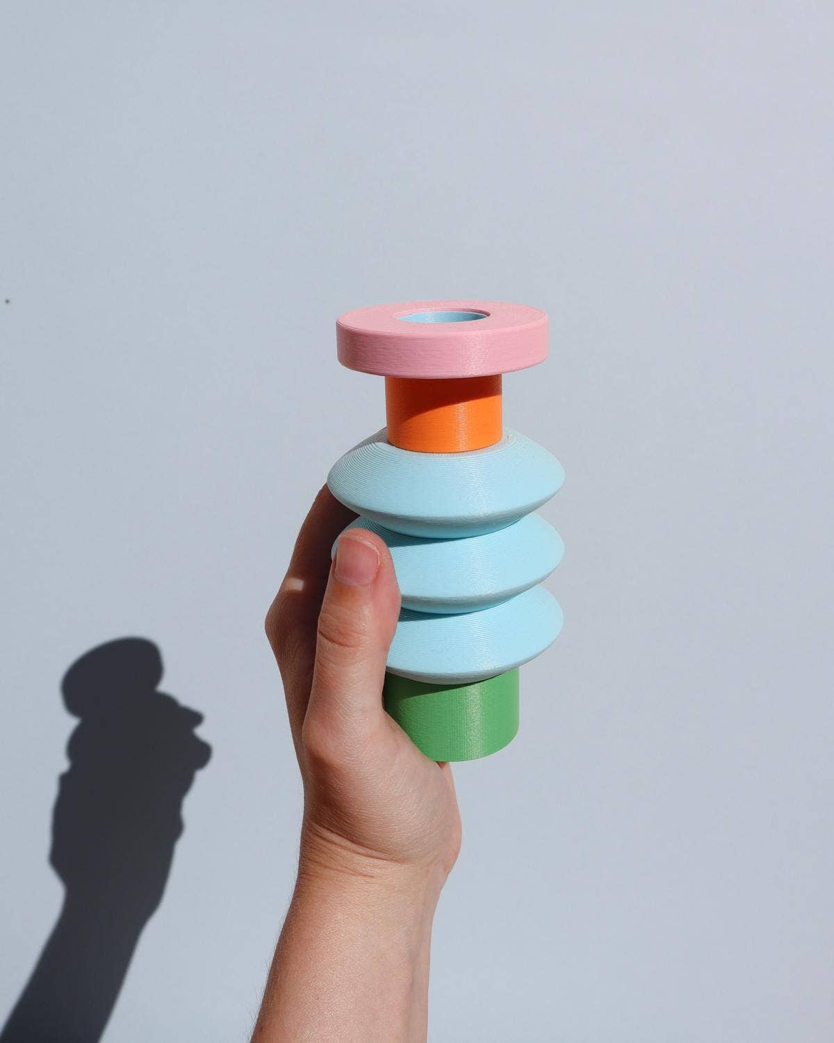 Space Color Block Vase with a hand holding it 