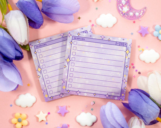 Two purple to-do lists on a pink background with flowers and decorative items.