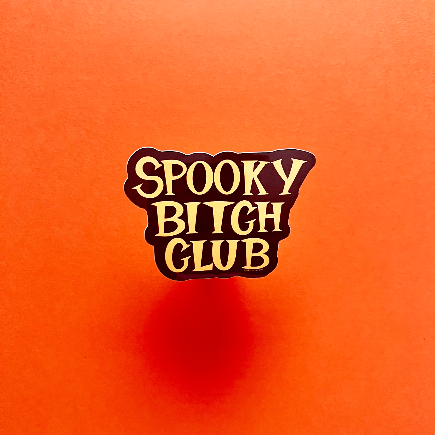 Sticker with 'Spooky Bitch Club' text on an orange background