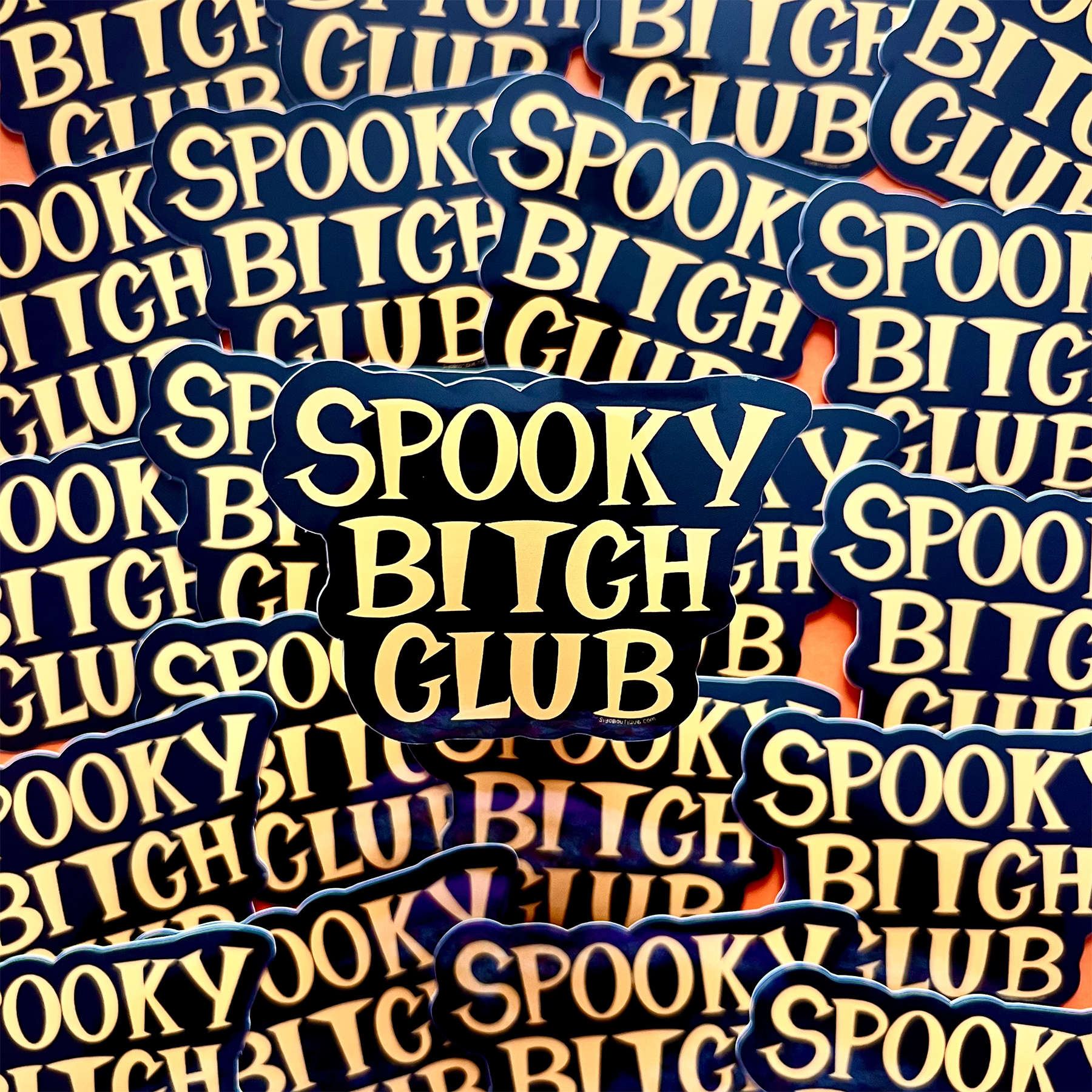 Stack of 'Spooky Bitch Club' stickers with blue and yellow text.