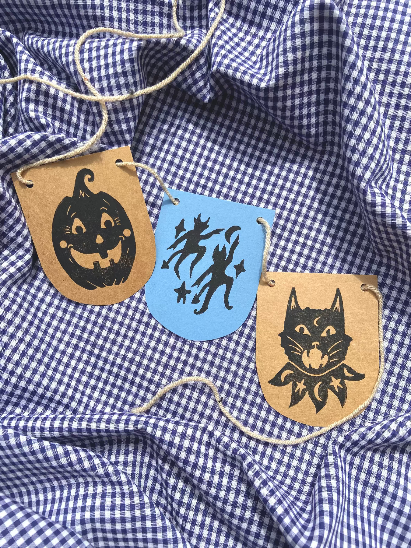 Decorative Halloween-themed patches on a blue and white checkered fabric. Block Print workshop