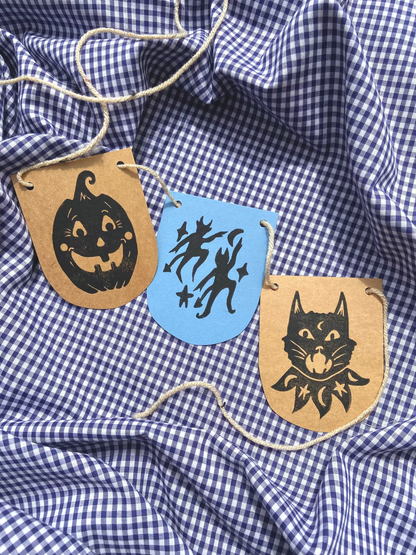 Decorative Halloween-themed patches on a blue and white checkered fabric. Block Print workshop