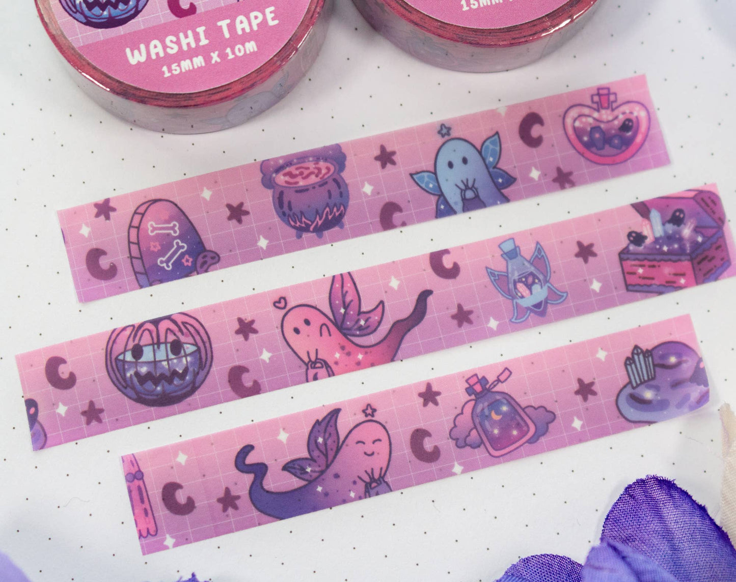Pink washi tape with cartoon designs on a white background