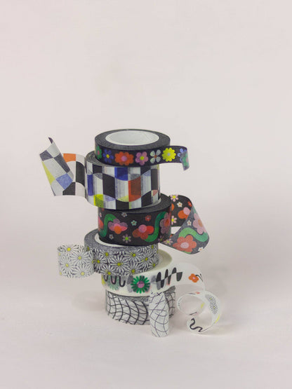 Stack of colorful washi tape rolls on a white background