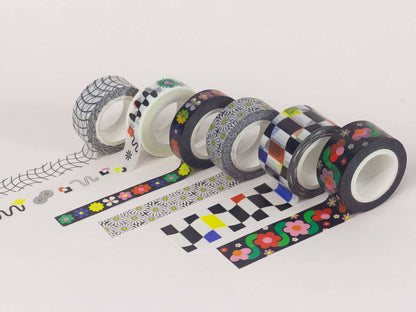 Assorted rolls of decorative tape with various patterns on a white background