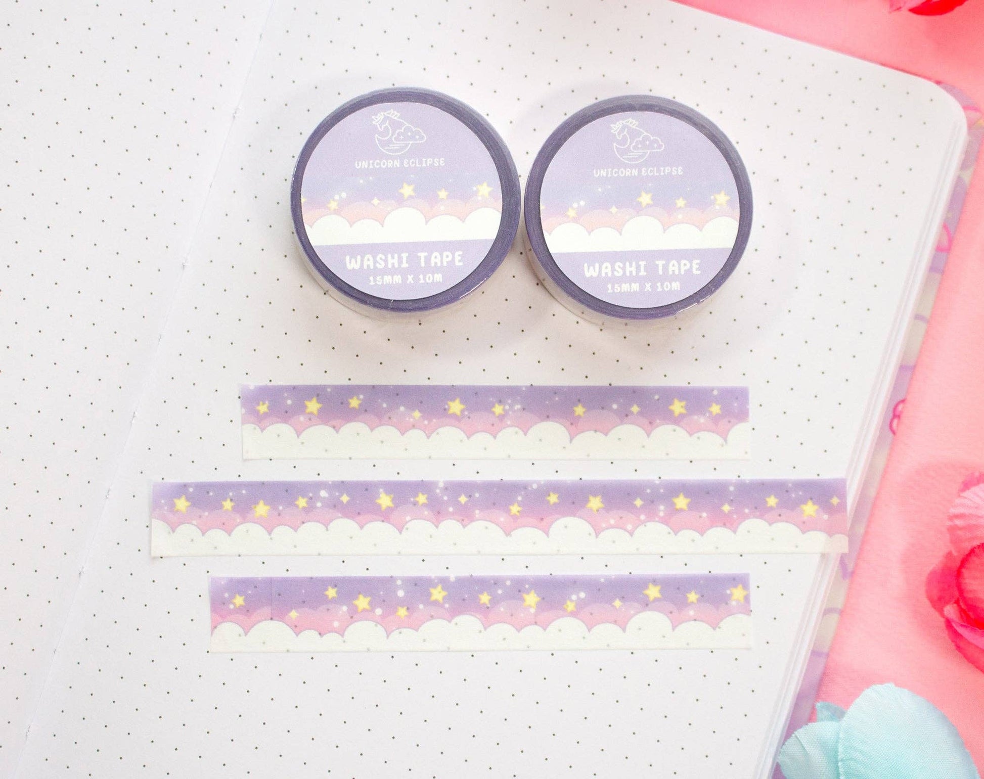 Two rolls of decorative washi tape with cloud and star design on a notebook page.