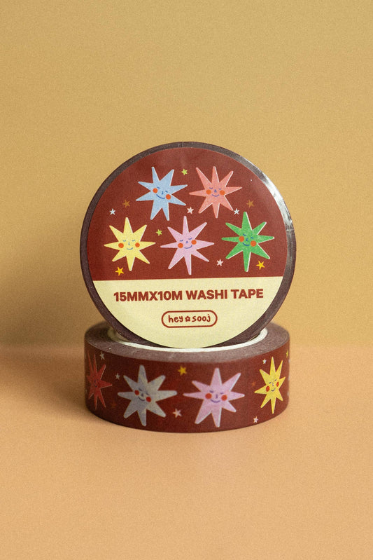 Washi tape with star designs on a brown background