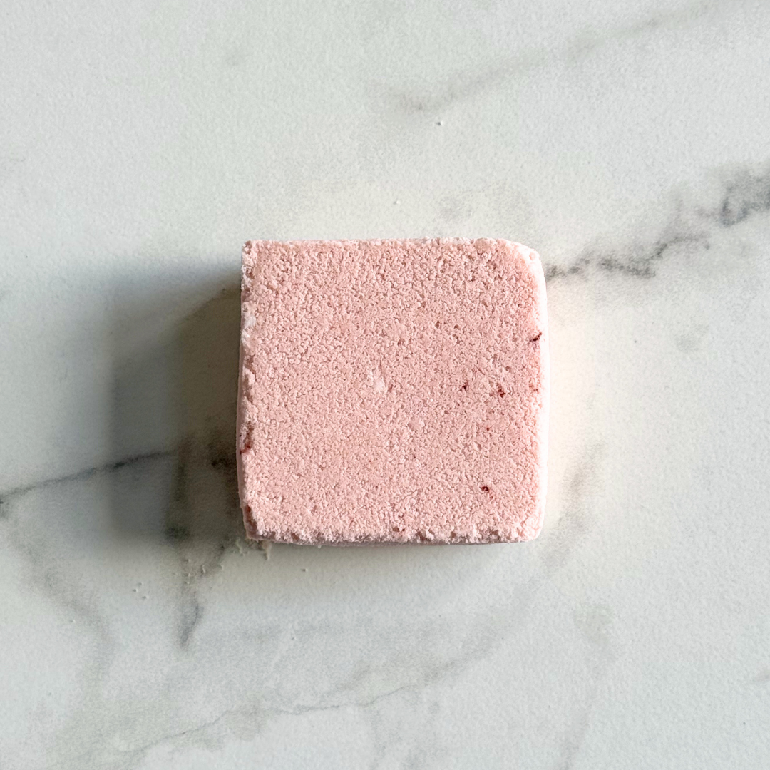 Pink square bath bomb on a marble surface