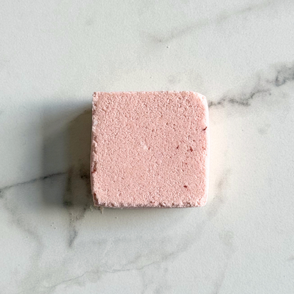 Pink square bath bomb on a marble surface