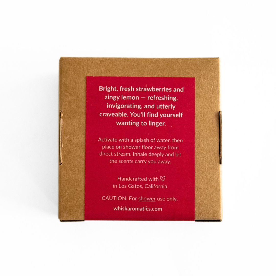 Whiskaromatics product packaging with red label and brown box on a white background