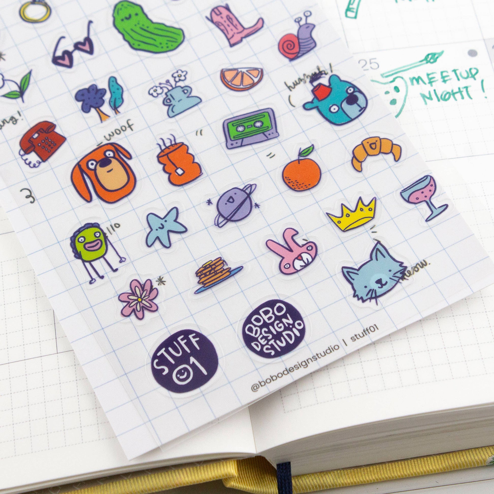 Collection of colorful stickers on a grid notebook page with 'Bobo & BoBo Design Studio' branding.