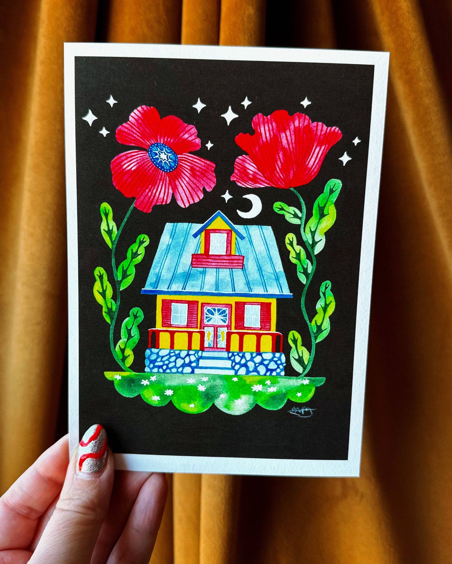 Colorful illustration of a house with flowers held against a brown curtain.