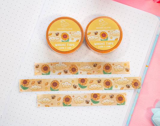 Two rolls of washi tape with sunflower designs on a white surface.