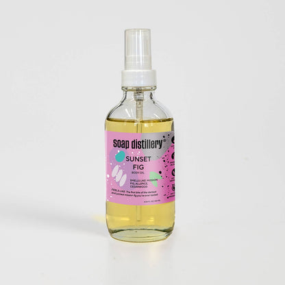 Bottle of Soap Distillery Sunset Fig body oil on a white background