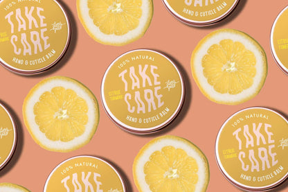 Pattern of 'Take Care' hand and cuticle balm containers with lemon slices on a peach background.