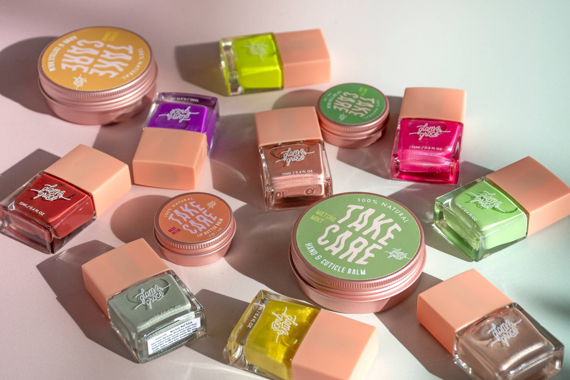 Collection of colorful lip balm containers on a light background