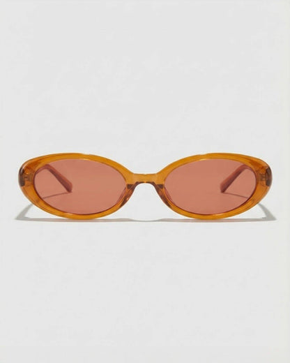 Sunglasses with a caramel colored  frame and pink lenses on a white background