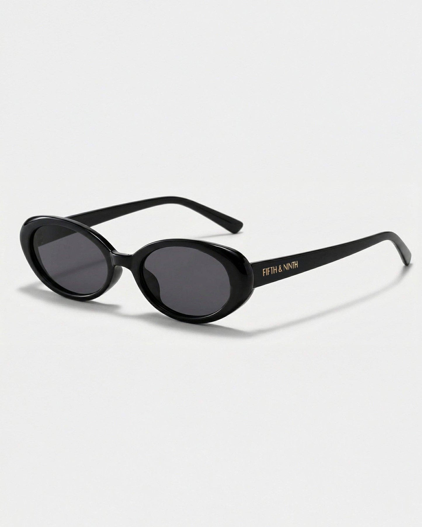 Black sunglasses with a brand logo on a light gray background