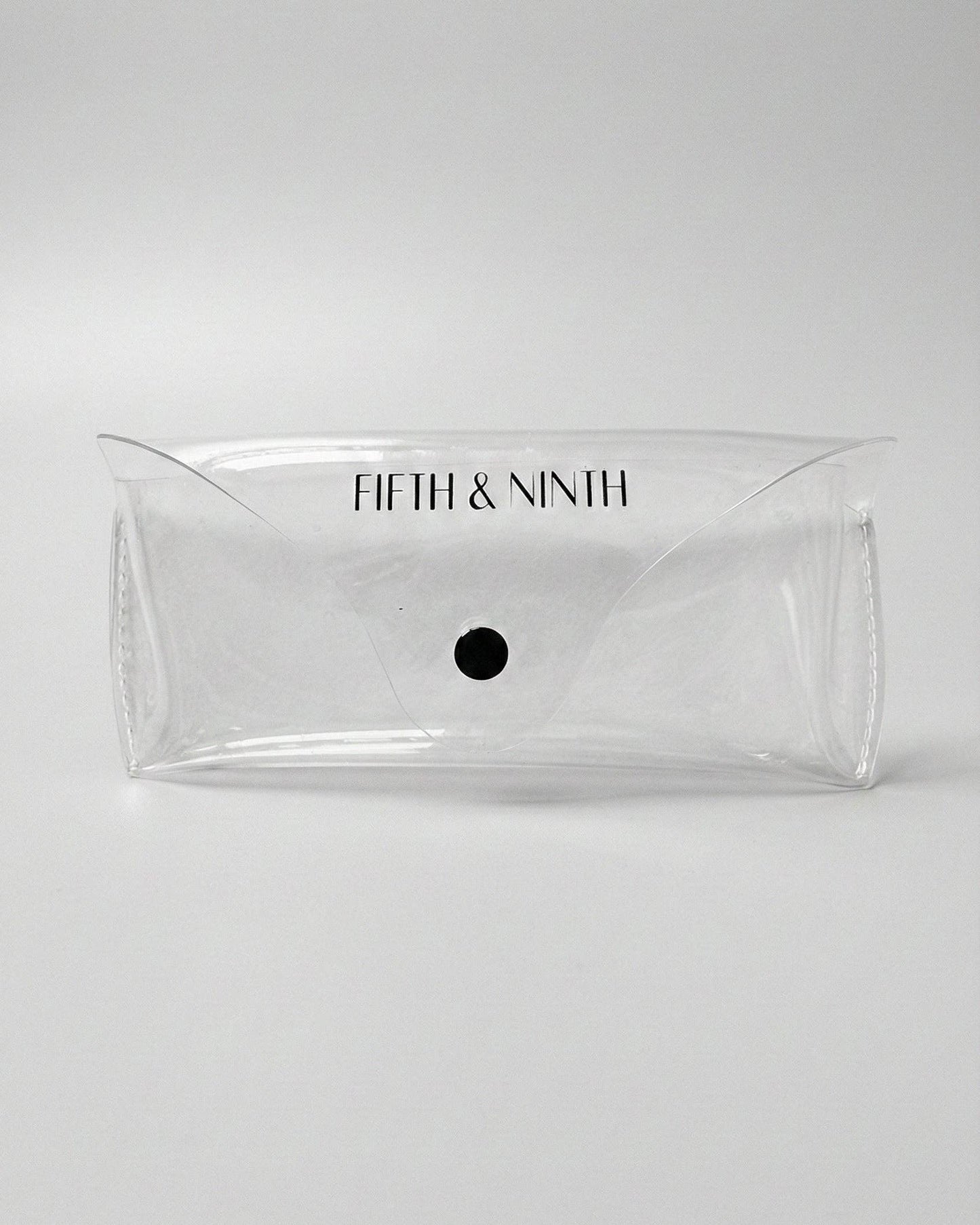 Clear pouch with 'Fifth & Ninth' branding on a white background