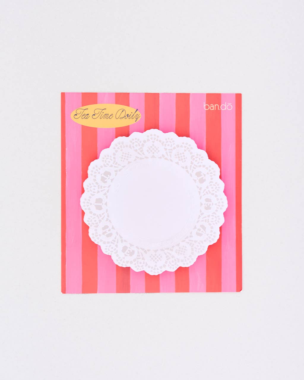 White lace doily notepad on a pink and red striped background with 'Tea Time Dots' branding.