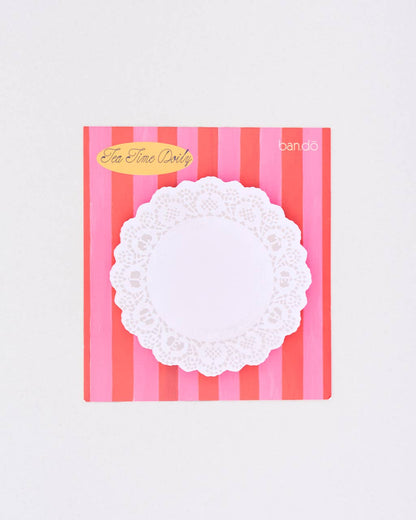 White lace doily notepad on a pink and red striped background with 'Tea Time Dots' branding.