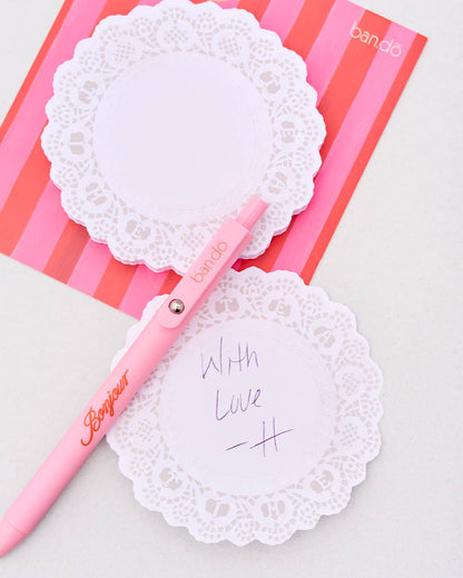 Pink pen with lace design on a pink and white striped background Tea_Time_Doily_Novelty_Notepad