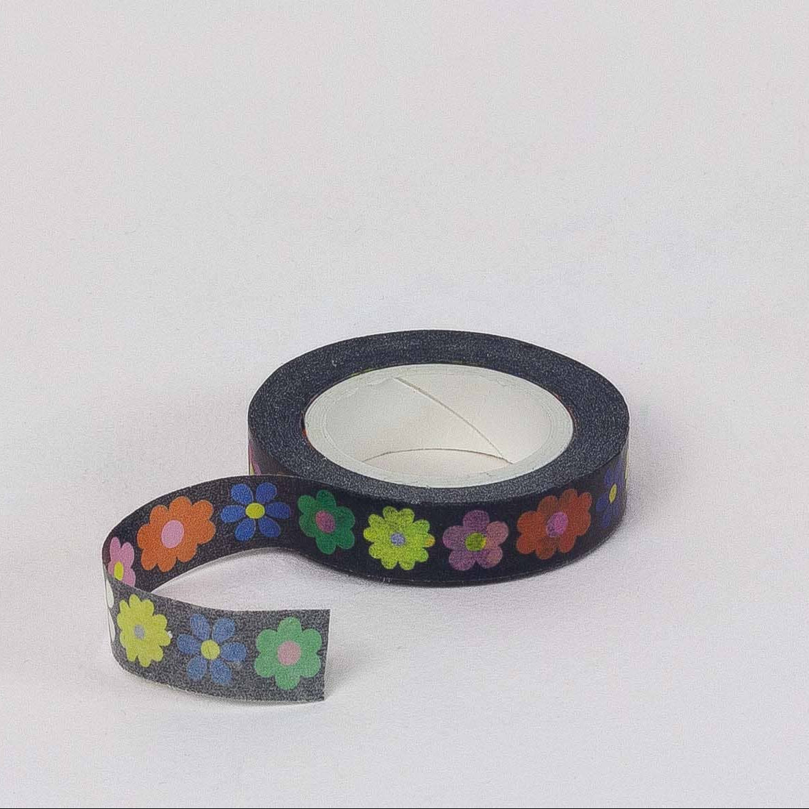 Roll of tape with colorful flower pattern on a white background