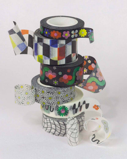 Colorful tape dispenser stack with decorative tapes on a white background