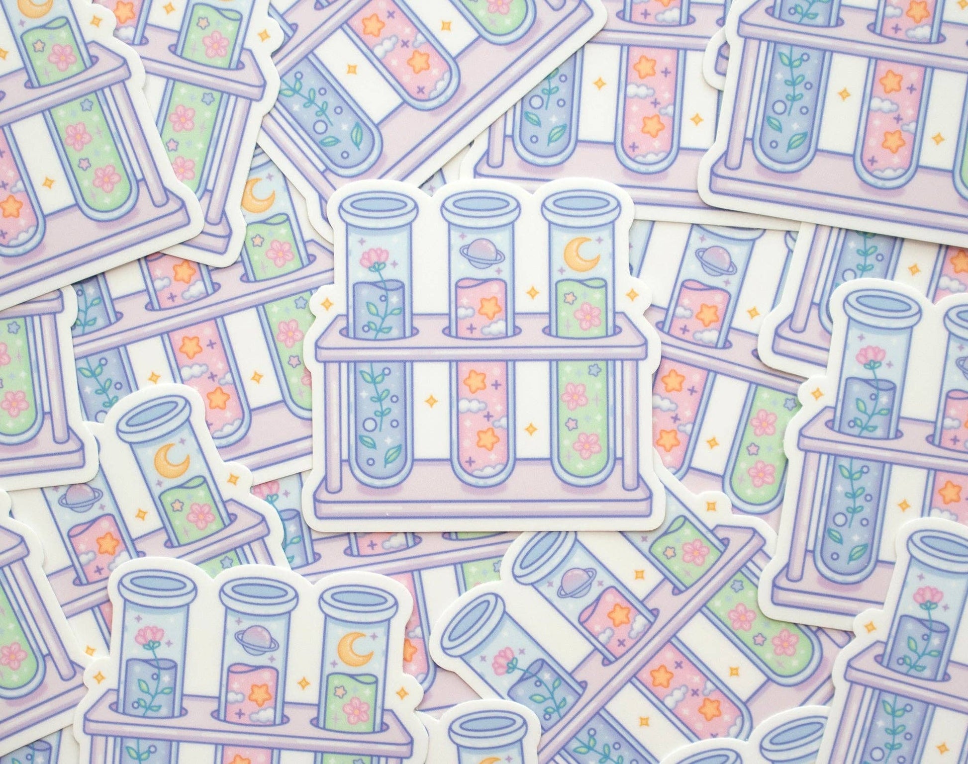 Pattern of test tubes and test tube racks with colorful liquids and flowers on a light background.